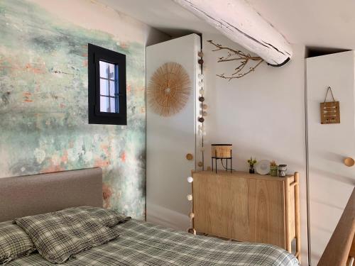 ein Schlafzimmer mit einem Bett und einem Wandgemälde in der Unterkunft Front de mer 35m2 vue époustouflante in Carry-le-Rouet