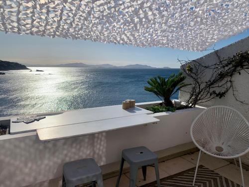 a view of the ocean from a balcony with chairs at Front de mer 35m2 vue époustouflante in Carry-le-Rouet