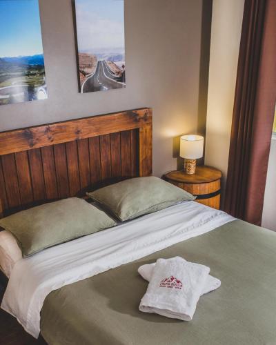 a bedroom with a bed with a towel on it at Casa Suiza in Santa Cruz