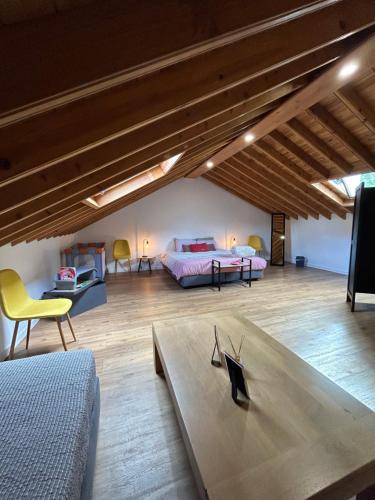 a large room with two beds and a tv at B&C Furnas House in Furnas