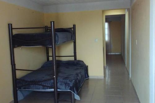 two bunk beds in a room with a hallway at Casa en Joyas Cuautitlan grande y cómoda in Cuautitlán