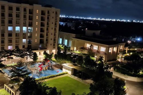 a view of a building with a park at night at Private room with air conditioning with private but non-attached bathroom Near airport in Devanhalli