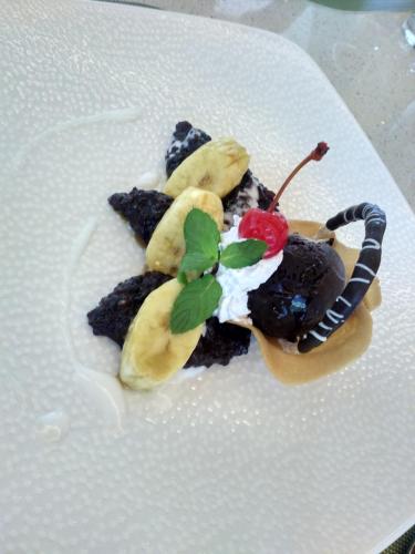 a white plate topped with a dessert on a table at SenS Hotel and Spa in Ubud