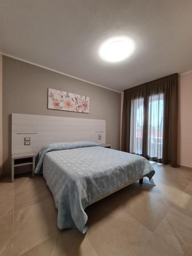 une chambre avec un grand lit dans une pièce dans l'établissement Le Anfore di Nora Domo, à Pula