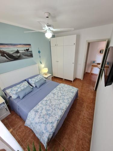 卡萊塔德菲斯泰的住宿－BAHIA AZUL，卧室配有一张床,墙上挂有绘画作品