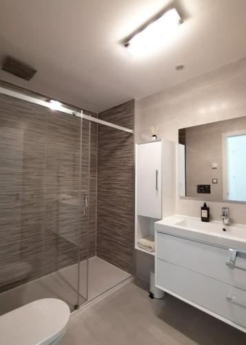 a bathroom with a shower and a sink and a toilet at Luxury Apartment Infinity View in Arenales del Sol