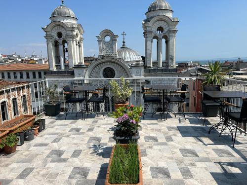 a patio with tables and chairs in front of a building at HOTEL GLOBAL 2022 in Istanbul