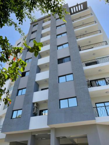 a tall white apartment building with windows at Go to the top in Dakar