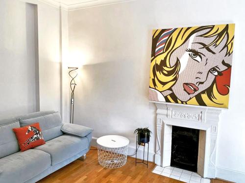 a living room with a couch and a painting on the wall at Amazing holidays home with a terrace in London