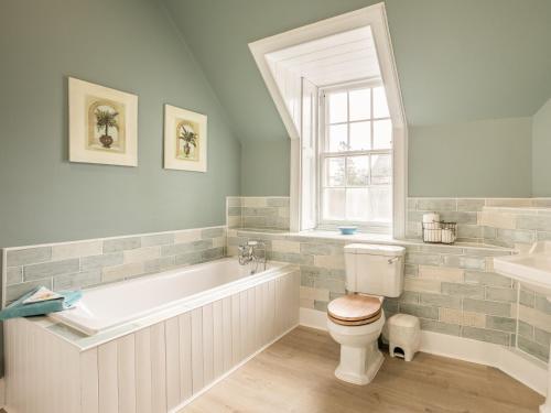 a bathroom with a tub and a toilet and a sink at Glen Apartment - Uk43813 in Ardovie