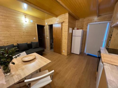ein Wohnzimmer mit einem Tisch und einem Kühlschrank in der Unterkunft Casa da Praia in Carvalhal