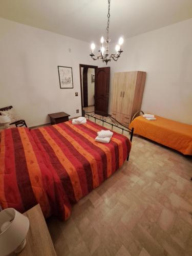 a large bedroom with a large bed and a chandelier at Casa Vacanza Pietro e Nina in Lecce