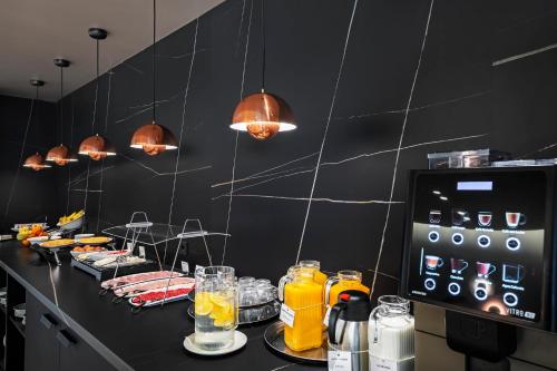 a kitchen with a counter with drinks on it at Holiday Inn Express Pamplona by IHG in Mutilva Baja