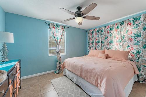 a bedroom with a bed and a ceiling fan at Bella Casa St Pete FL in St Petersburg