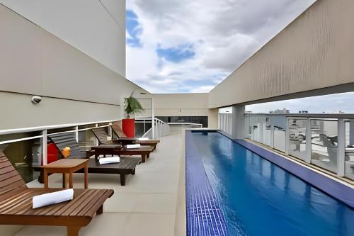 a swimming pool on the roof of a building at True América apart-hotel in Campos dos Goytacazes
