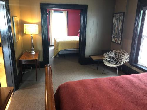a bedroom with a bed and a mirror and a chair at Lady Hamilton in Stratford