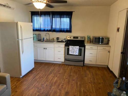 a kitchen with a white refrigerator and a stove at 3 bedroom, 2 bath 1 min walk to the beach in Bullhead City