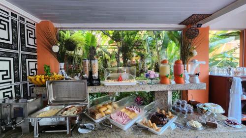 a buffet with food on display in a room at Pousada Caminho da Serra Paraty in Paraty