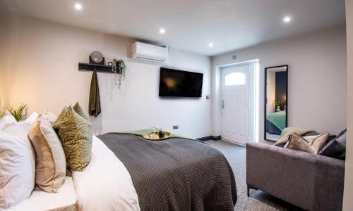 a bedroom with a bed and a couch at The Rampart in Great Yarmouth