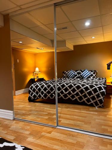 a bedroom with a bed and a mirrored wall at The Rustic Barn in Brampton