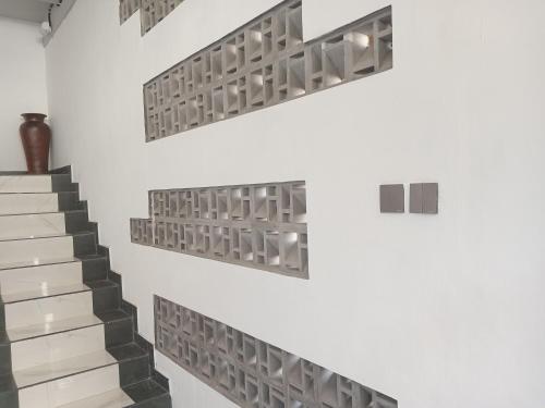 a staircase with metal shelves on the wall at 9 Residences Seminyak in Seminyak