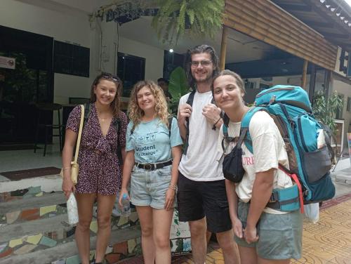 a group of people standing in front of a house at Sweed Dee Hostel in Phi Phi Don