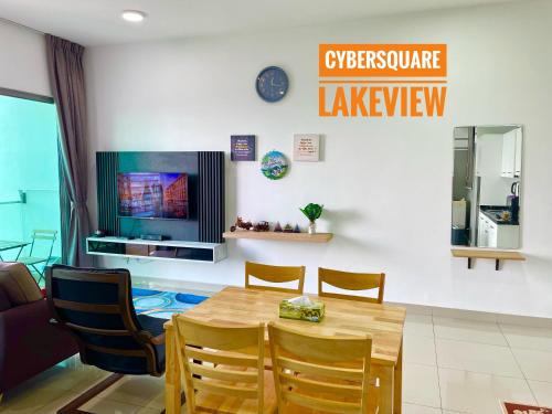 a dining room with a wooden table and chairs at Cybersquare Lakeview with Netflix and Disney Hotstar in Cyberjaya