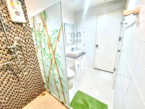 a bathroom with a shower and a toilet and a sink at The IRIS no.301 : 2 Bedrooms near Huamark Station in Ban Bang Toei (1)