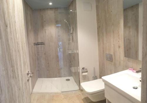 a bathroom with a shower and a toilet and a sink at Modern Style Serviced Apartment at Fouka Bay North Coast with Pool and Sea View in Marsa Matruh
