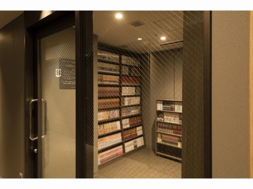 a hallway of a store with shelves of books at HOTEL OLE INN in Shizuoka