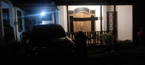 a car parked in front of a house with a door at Homestay dwi prasetyo in Kembanglimus