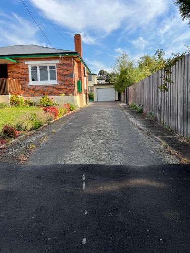 an empty driveway in front of a house at A lovely studio in Kings Meadows in Kings Meadows