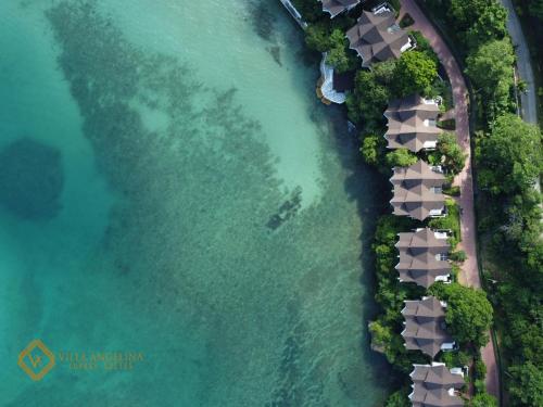 an aerial view of a beach with a resort at Villa Angelina Luxury Suites in Dapitan