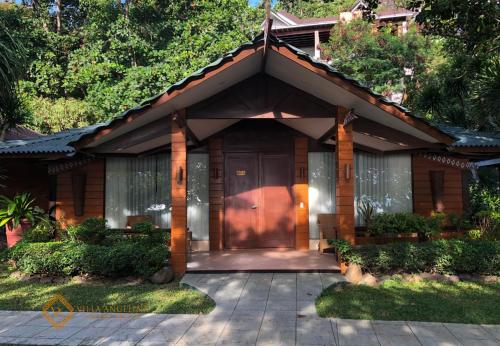 a house with a large door in front of it at Villa Angelina Luxury Suites in Dapitan