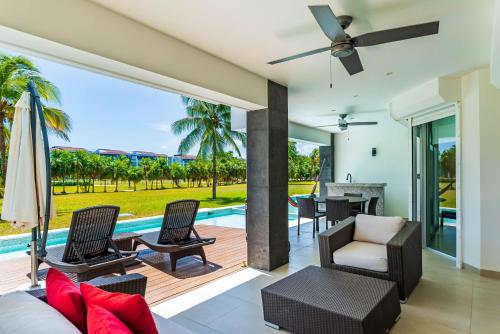 a living room with a patio and a pool at Mareazul Beach Front Condos At playa del Carmen in Playa del Carmen