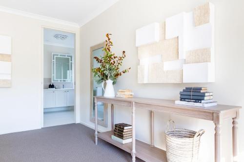 a living room with a console table and a mirror at Bridgewater in Bright