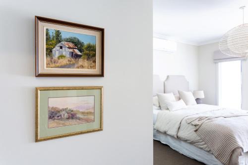 a bedroom with two framed paintings on the wall at Bridgewater in Bright