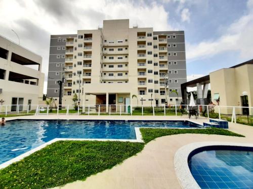 a swimming pool in front of a building at Apto novo Parque Mosaico in Manaus