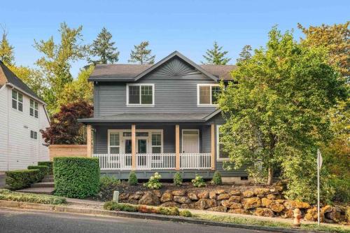 a gray house with a stone retaining wall at Private Newly Renovated Studio w private Parking! in Portland