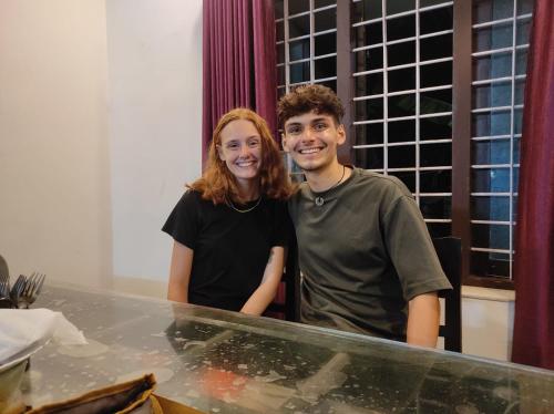 a man and a woman standing in front of a counter at Venitia Homestay in Alleppey