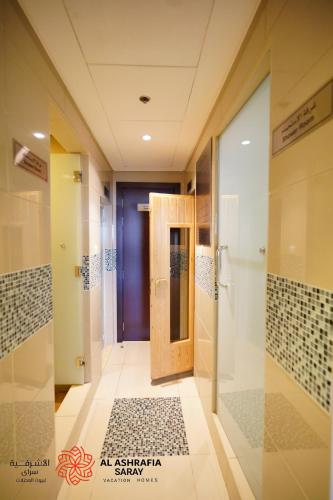 a hallway with a door in a building at Alashrafia Saray - Wonderful 1BR in Sports City in Dubai