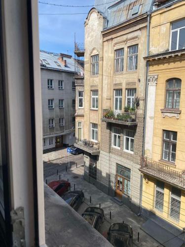 a view of a city street from a window at LvApart вул Ковжуна 2 кім ізол кухня студія звітні документи in Lviv