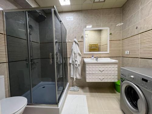 a bathroom with a shower and a toilet and a sink at Park Azure 11446 in Baku