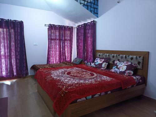 a bedroom with a large bed with purple curtains at Karpagam Residency in Ooty