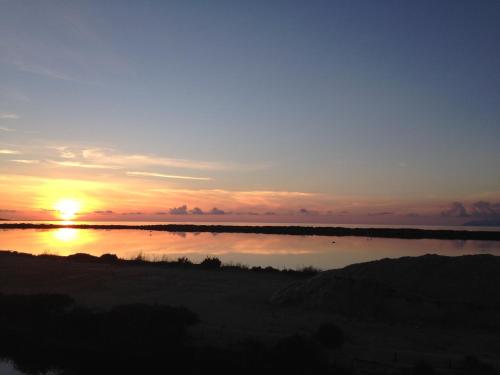 a sunset over a body of water with at B&B Al Vecchio Pontile Sea View in Marsala
