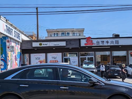 a car is parked in front of a store at Nice home away at Vancouver near YVR in Vancouver