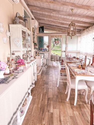 a kitchen with a table and a dining room at La Casa Di Menny Maison de Campagne in Moneglia