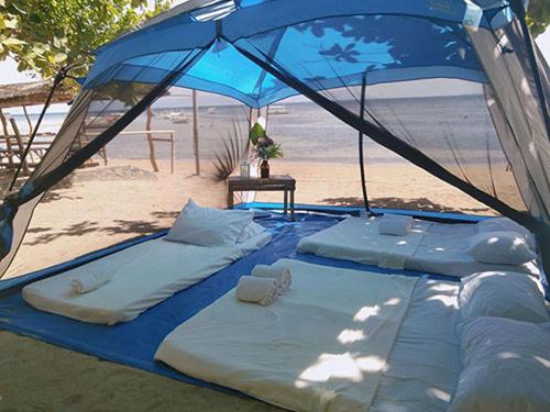 a blue tent on the beach next to the beach at Casa Astillero - Calatagan Batangas Private Resort in Calatagan
