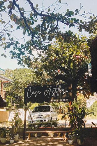 a sign with a car parked next to a tree at Casa Astillero - Calatagan Batangas Private Resort in Calatagan