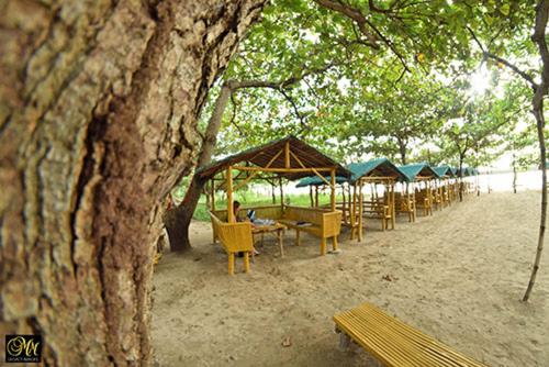 a row of tables and chairs on a beach at Casa Astillero - Calatagan Batangas Private Resort in Calatagan